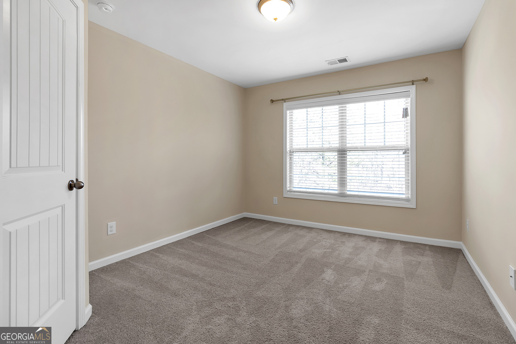 836 Ivy Vine Way Milton, GA 30004 - Photo 13 of 16 a view of an empty room with a window