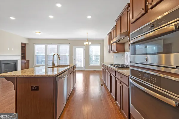 a kitchen with counter top space and stainless steel appliances