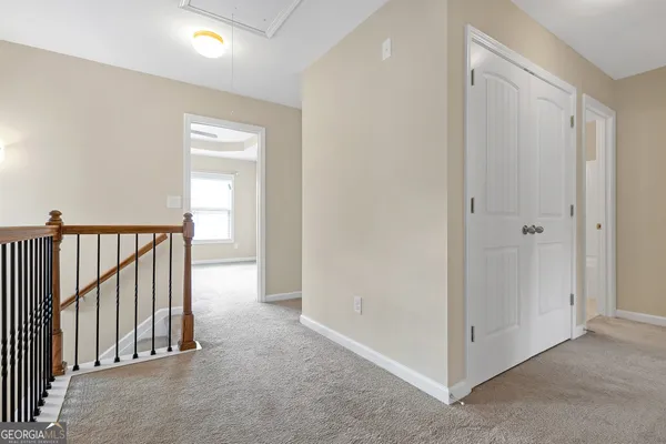 a view of a hallway with entryway in a hall