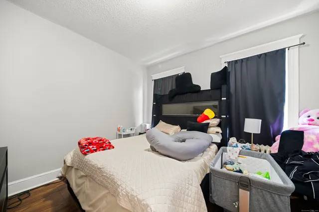 a bedroom with bed and window