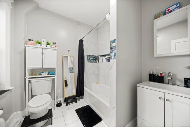 a bathroom with a toilet a sink and a shower