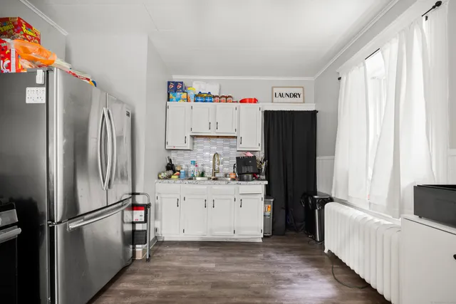 a kitchen with refrigerator a microwave and cabinets