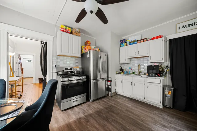 a kitchen with a refrigerator and a stove top oven