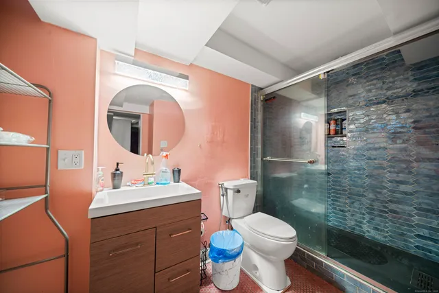 a bathroom with a sink mirror vanity and toilet