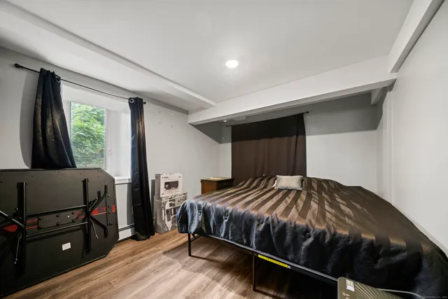 a bedroom with a bed and a window