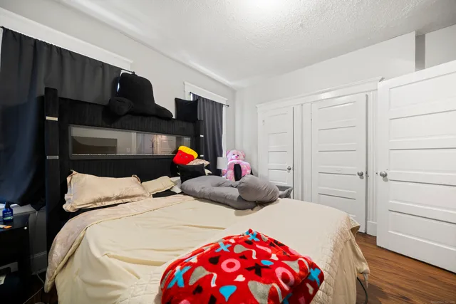 a bedroom with two beds and a closet