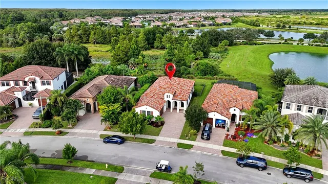 an aerial view of residential houses with outdoor space and lake view