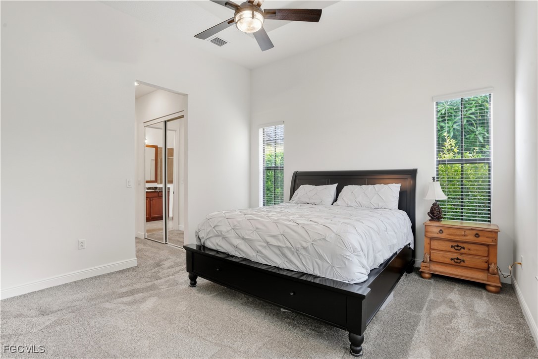 5355 Ferrari Avenue Ave Maria, FL 34142 - Photo 12 of 28 a bedroom with a bed and a chandelier