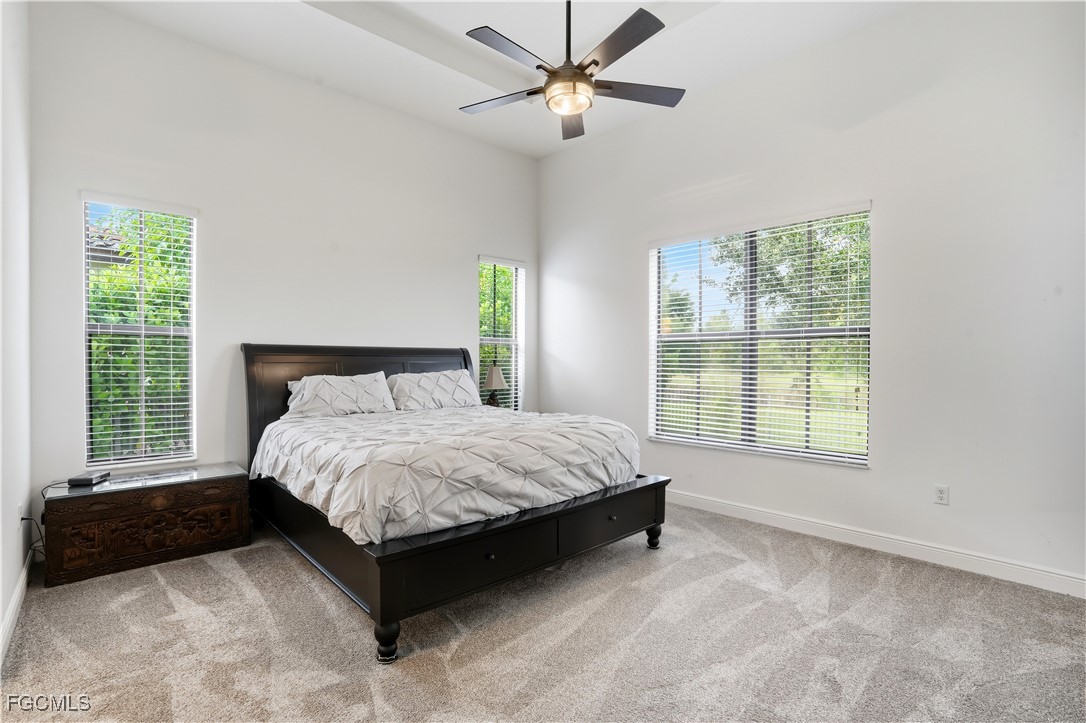 5355 Ferrari Avenue Ave Maria, FL 34142 - Photo 13 of 28 a spacious bedroom with a bed and a window