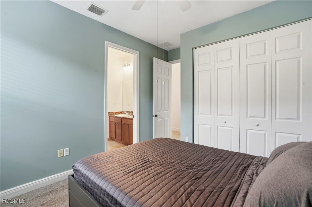 5355 Ferrari Avenue Ave Maria, FL 34142 - Photo 17 of 28 a bedroom with a bed and wooden floor