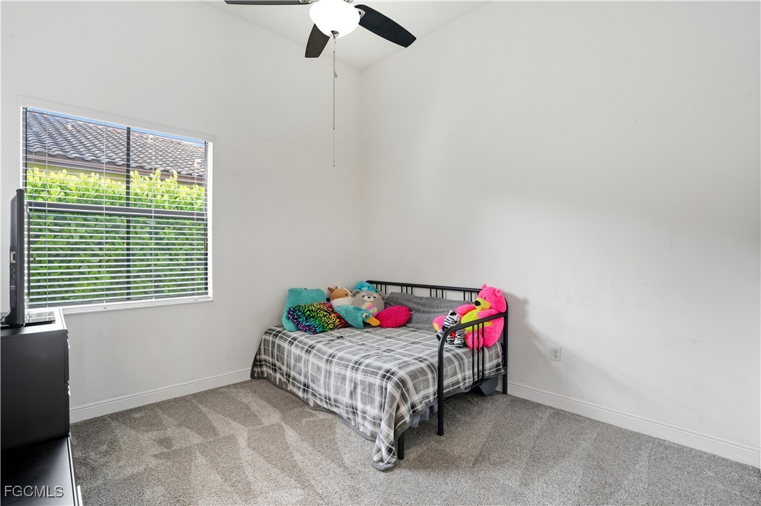 5355 Ferrari Avenue Ave Maria, FL 34142 - Photo 20 of 28 a bed sitting in a bedroom next to a window