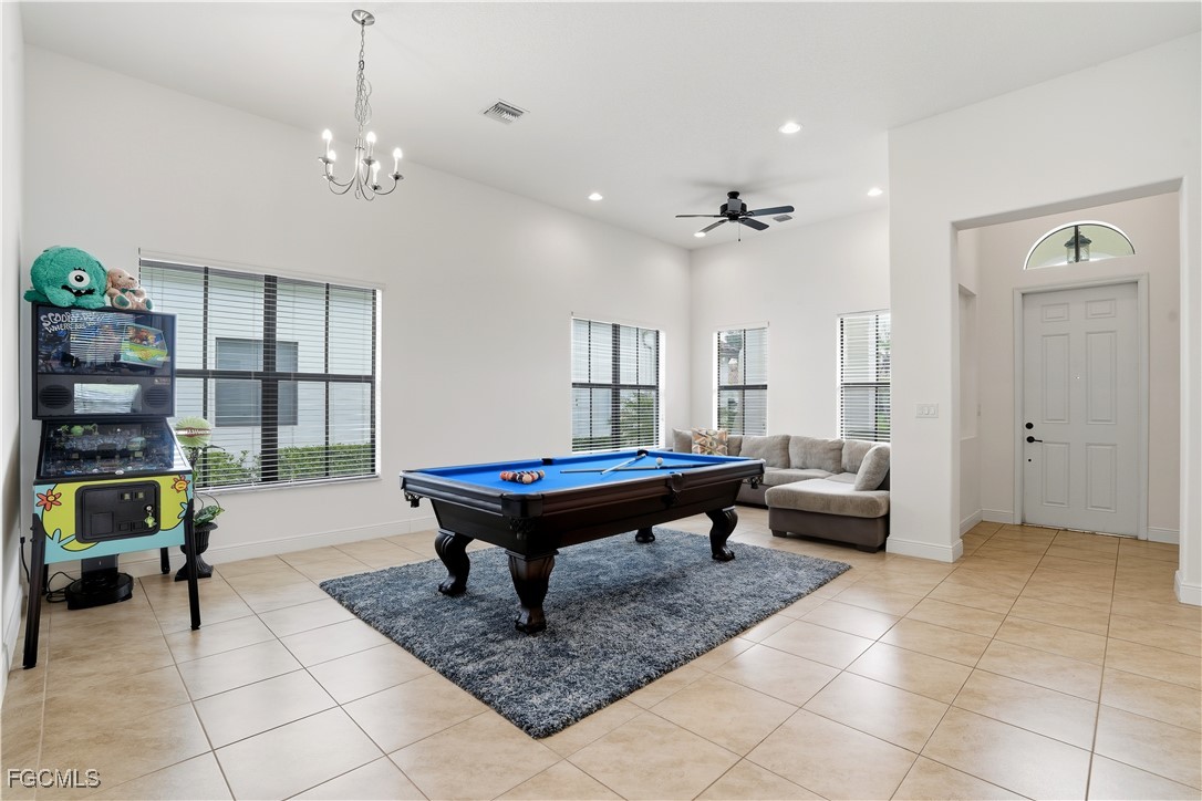 5355 Ferrari Avenue Ave Maria, FL 34142 - Photo 6 of 28 a living room with furniture and a chandelier