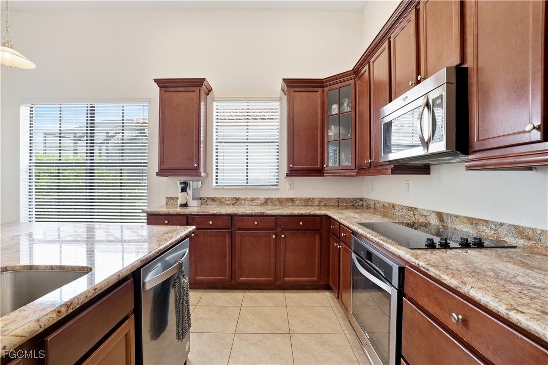 5355 Ferrari Avenue Ave Maria, FL 34142 - Photo 8 of 28 a kitchen with stainless steel appliances granite countertop a sink and a stove