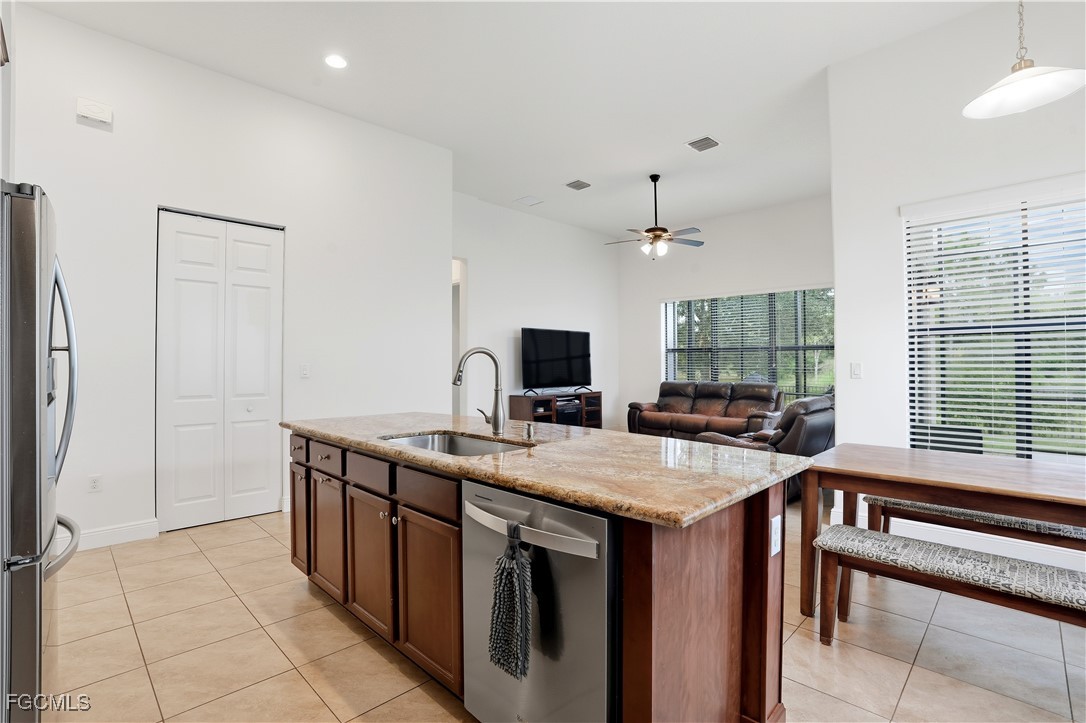 5355 Ferrari Avenue Ave Maria, FL 34142 - Photo 9 of 28 a kitchen with a stove a sink and a refrigerator