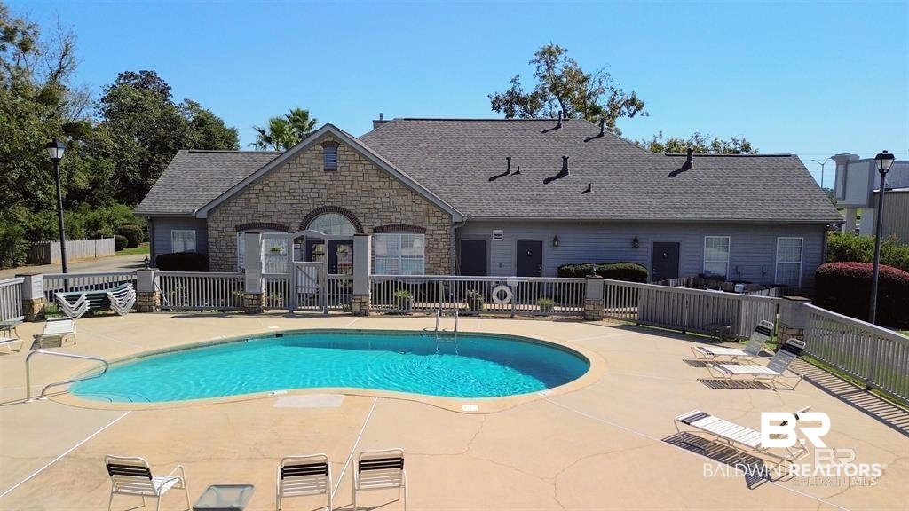 303 Wyld Palms Drive, Unit 303 Foley, AL 36535 - Photo 26 of 36 Community pool with a patio area