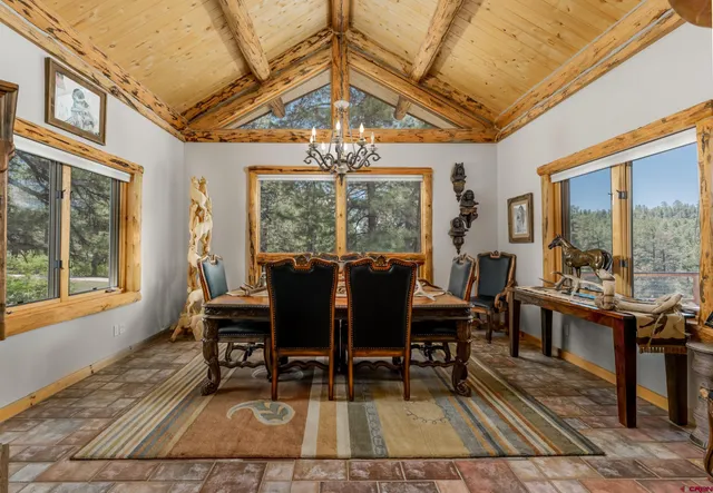 a view of a dining room with furniture a chandelier and wooden floor