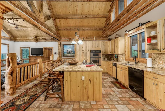a kitchen with stainless steel appliances granite countertop a sink and cabinets