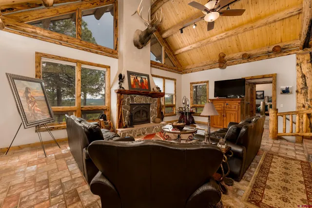 a living room with fireplace furniture and a fireplace