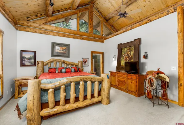 a bedroom with a bed and a baby crib