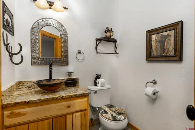 a bathroom with a toilet sink and mirror