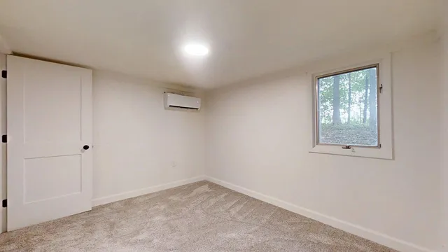 a view of a room with wooden floor and window