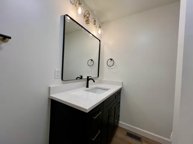 an empty room with wooden floor and window