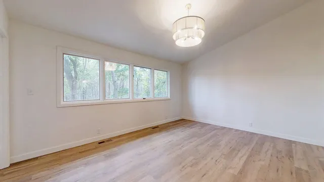 a bathroom with a toilet sink vanity and mirror
