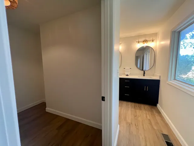wooden floor in an empty room with a window