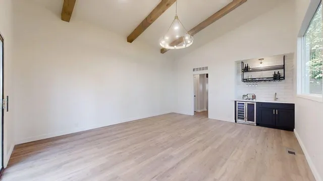 a view of wooden floor and windows in a room