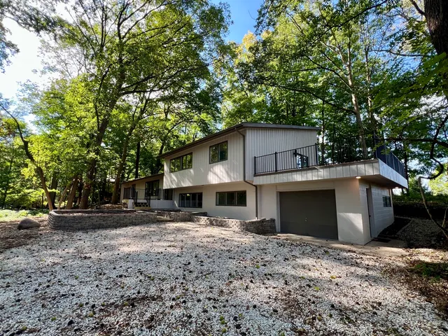an empty room with wooden floor and fireplace