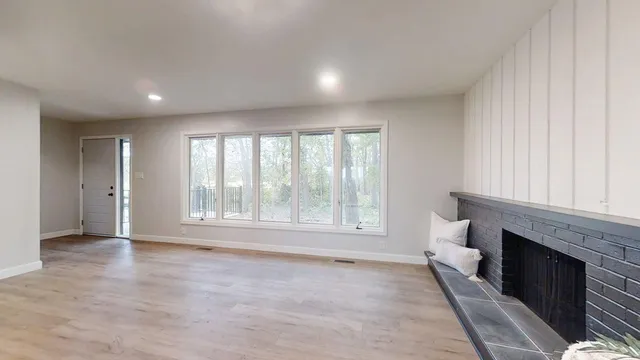 wooden floor in an empty room with a fireplace