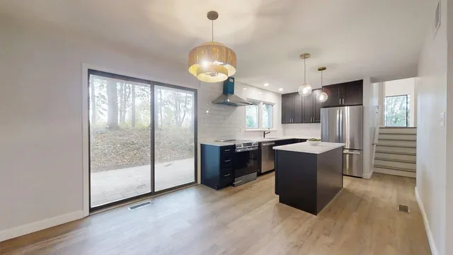 a kitchen with a sink stove and refrigerator