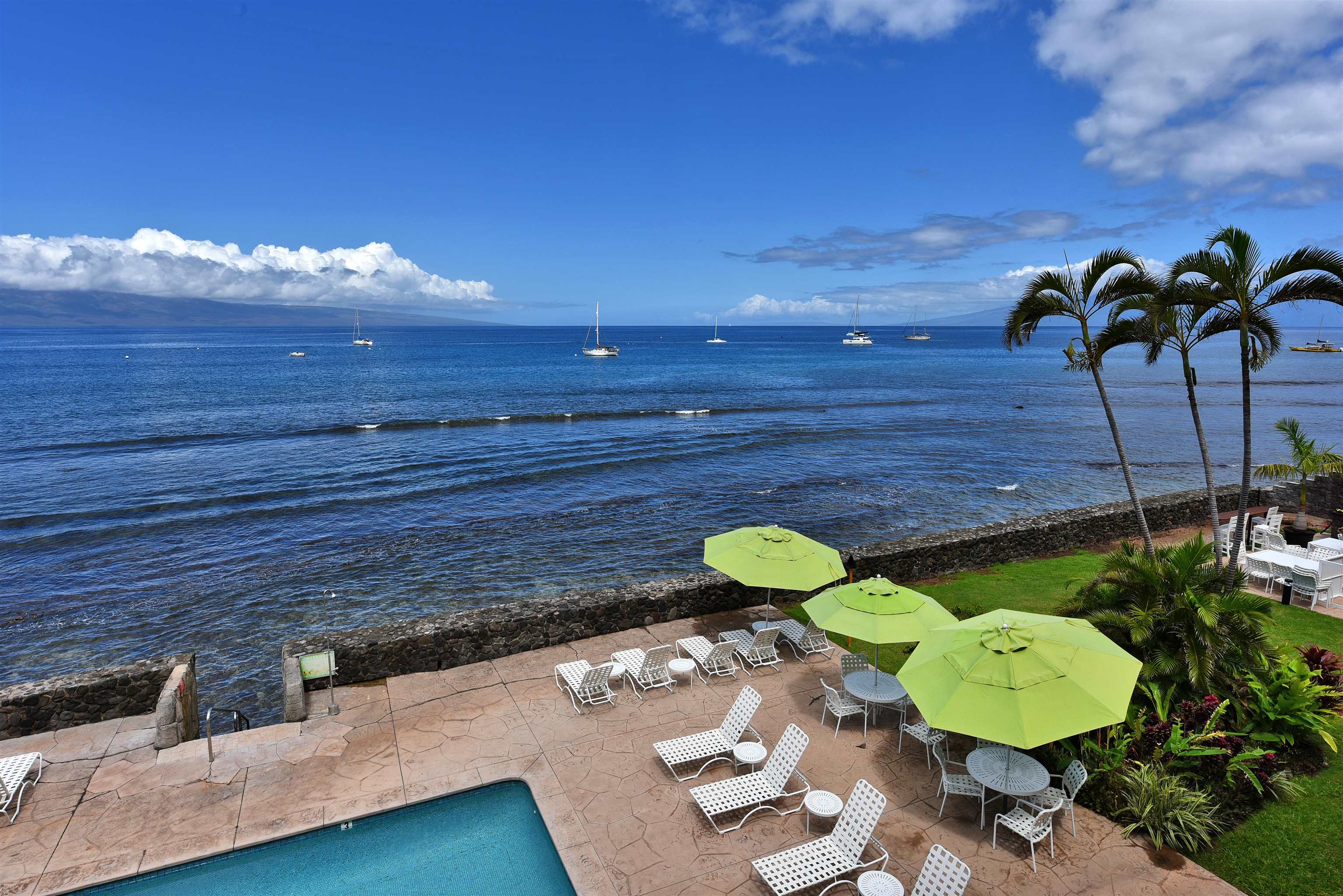 1403 Front Street, Unit 308 Lahaina, HI 96761 - Photo 3 of 35 a view of a swimming pool with a chairs and a table