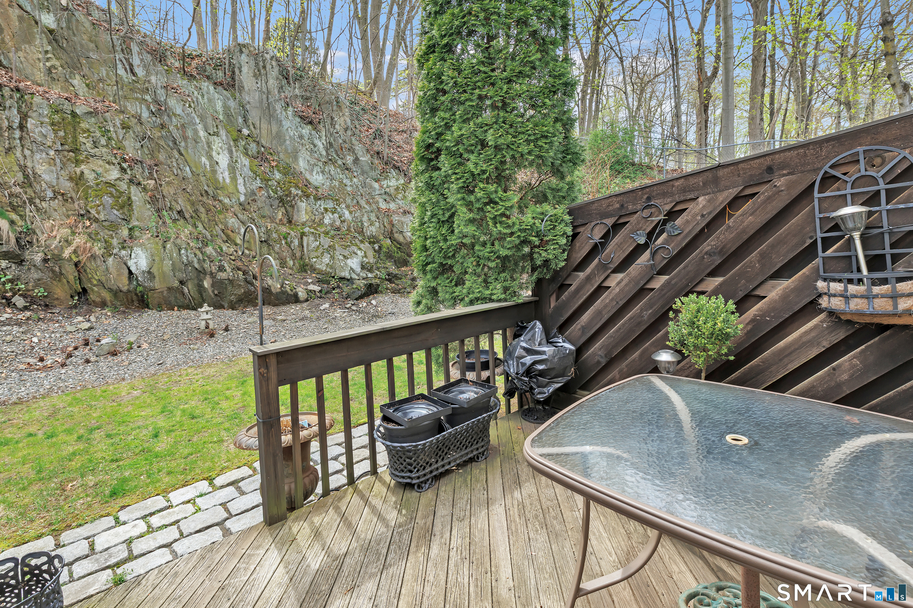 146 Howe Avenue, Unit 146 Shelton, CT 06484 - Photo 14 of 35 a view of a balcony with chairs and wooden fence
