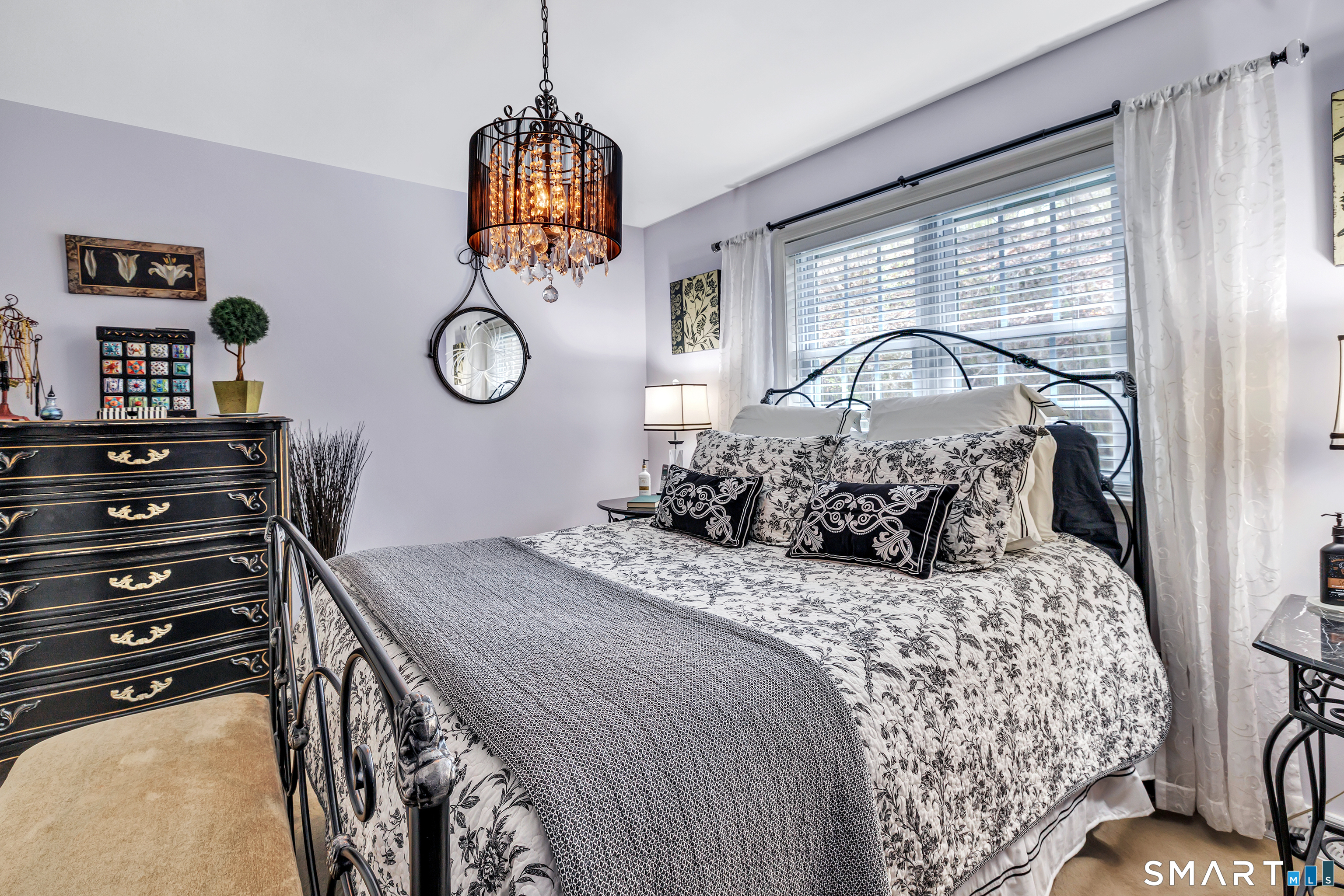 146 Howe Avenue, Unit 146 Shelton, CT 06484 - Photo 24 of 35 a bedroom with a bed and a chandelier