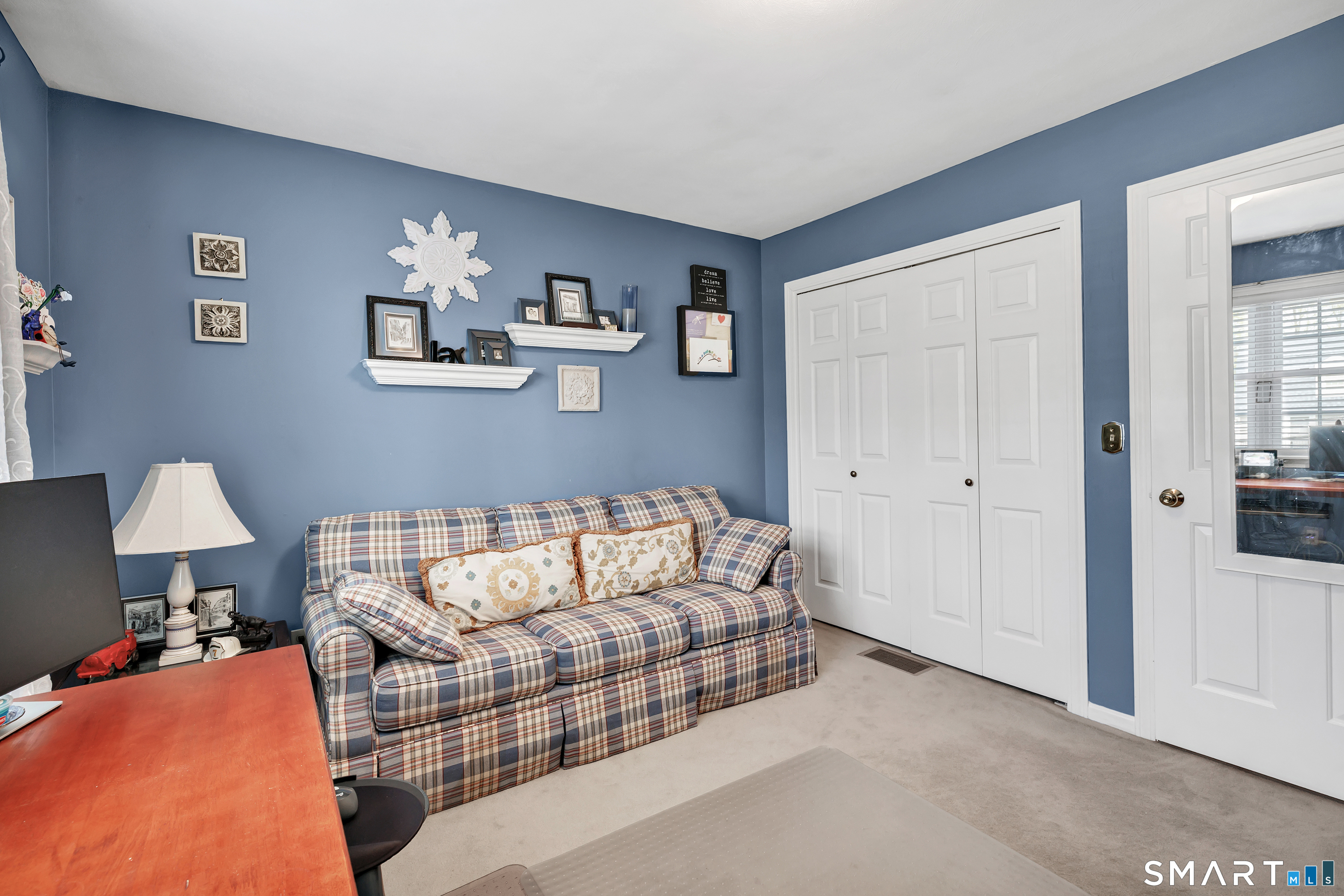 146 Howe Avenue, Unit 146 Shelton, CT 06484 - Photo 30 of 35 a living room with furniture and a lamp