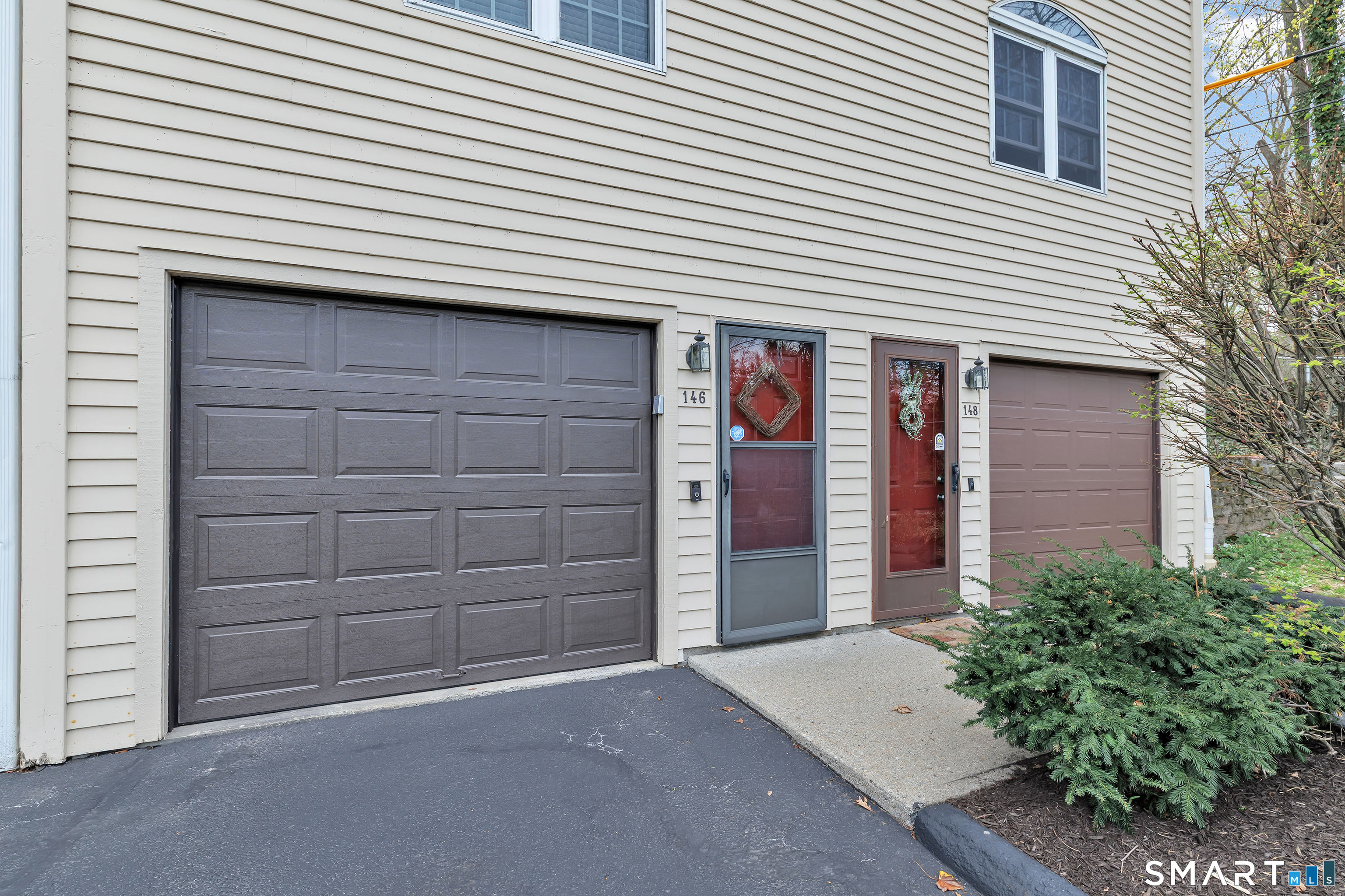 146 Howe Avenue, Unit 146 Shelton, CT 06484 - Photo 3 of 35 a front view of a house with a garage