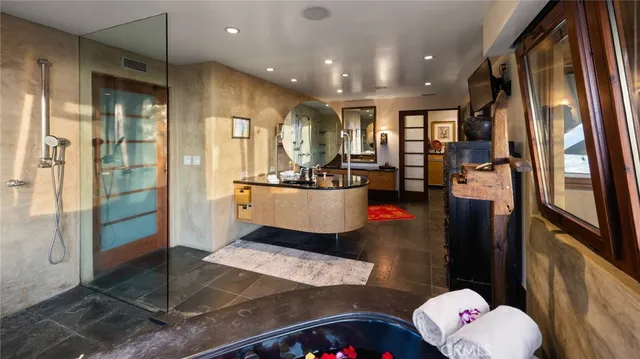 a living room with stainless steel appliances furniture a rug and a view of kitchen