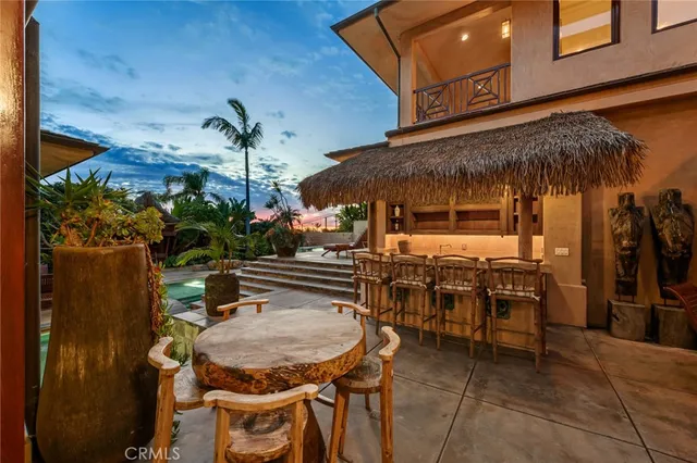 a view of a patio with table and chairs potted plants