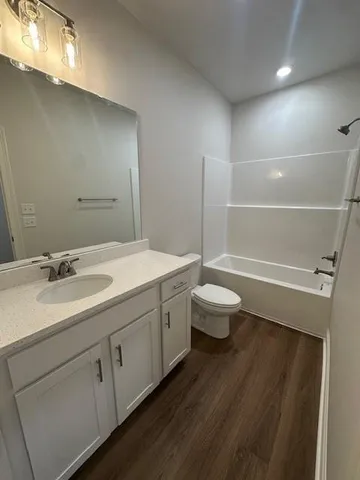 a bathroom with a double vanity sink toilet and a shower