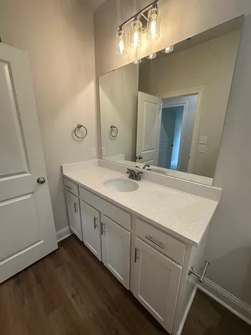 a bathroom with a double vanity sink and a mirror