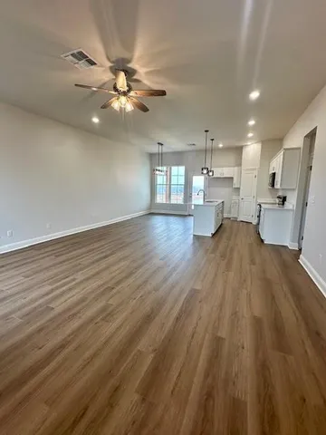 a view of a kitchen with a sink wooden floor and a counter top space