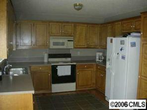 4037 Davis Road Maiden, NC 28650 - Photo 4 of 4 a kitchen with stainless steel appliances granite countertop a refrigerator and a stove