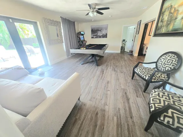 a living room with furniture and a wooden floor