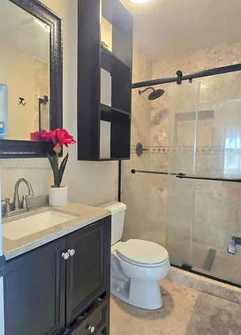 a bathroom with a sink toilet and shower
