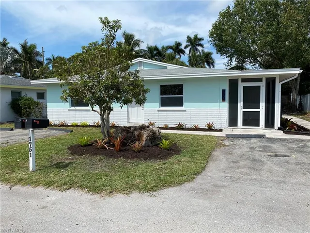 a view of a house with yard and a garden