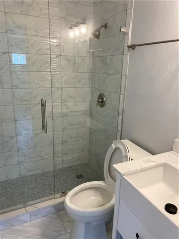 a bathroom with a sink toilet and shower