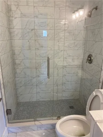 a bathroom with a toilet and shower