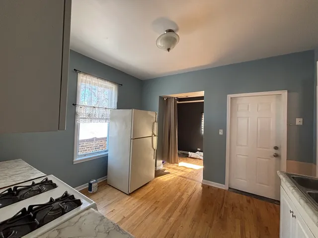 a kitchen with a refrigerator and a stove