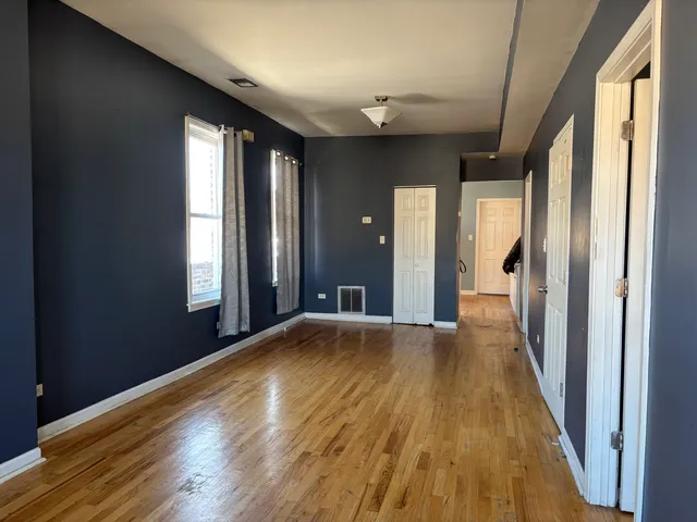 a view of a livingroom with wooden floor and a window